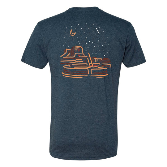 Blue t-shirt with a graphic desert night sky design on the back against a white background