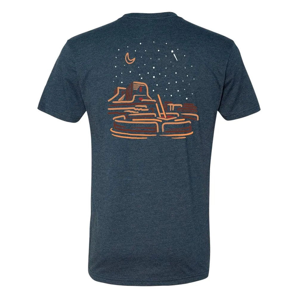 Blue t-shirt with a graphic desert night sky design on the back against a white background
