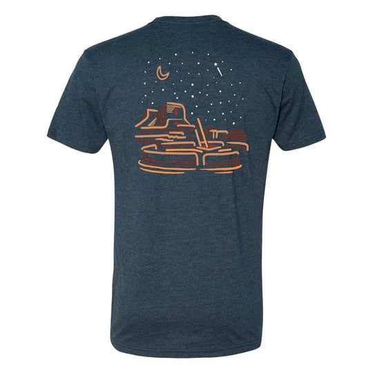 Blue t-shirt with a graphic desert night sky design on the back against a white background