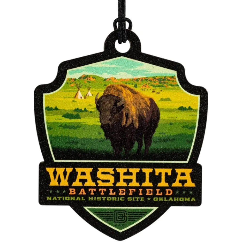 Badge-shaped ornament with a bison and text about Washita Battlefield National Historic Site, Oklahoma.