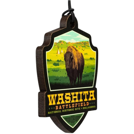 Badge-shaped ornament with a bison and text about Washita Battlefield National Historic Site, Oklahoma.