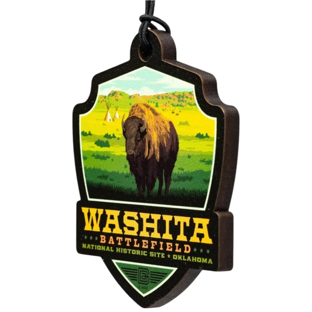Badge-shaped ornament with a bison and text about Washita Battlefield National Historic Site, Oklahoma.