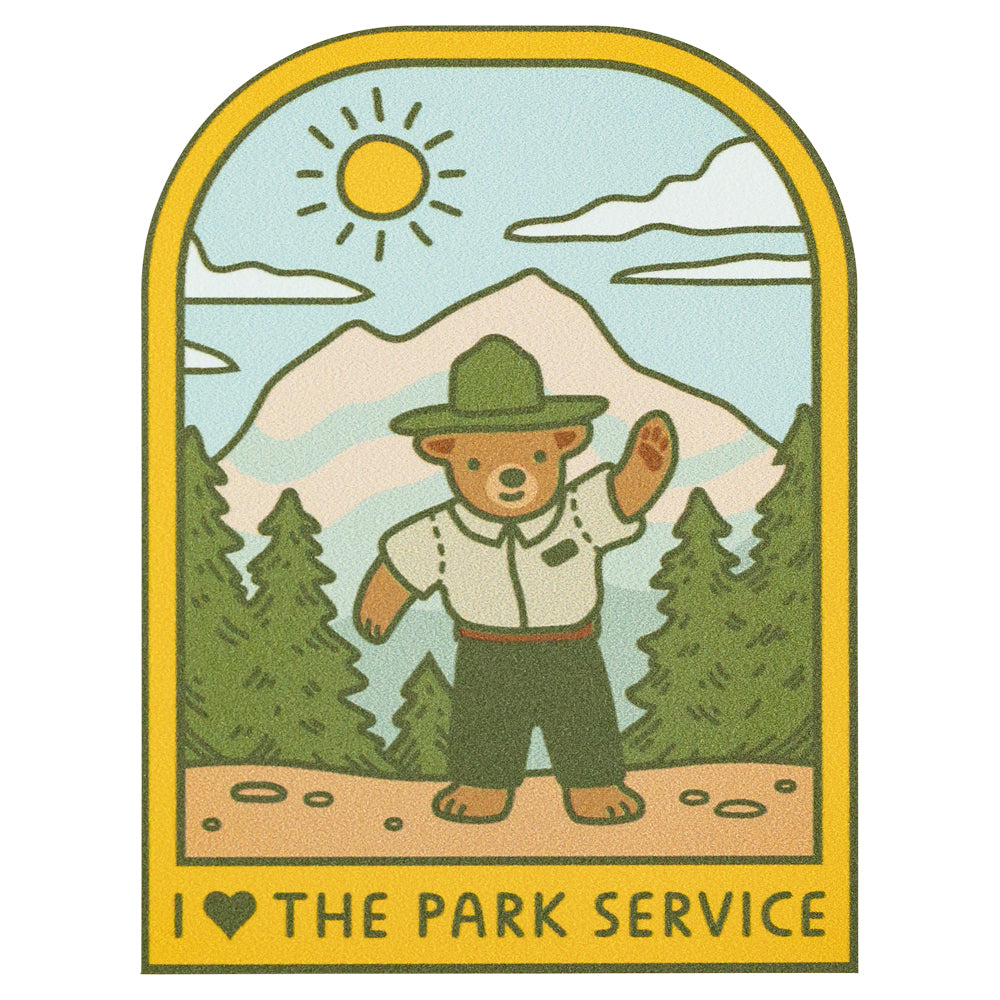 Illustration of a bear in a park ranger outfit with mountains and trees in the background, featuring the text 'I love the Park Service'.