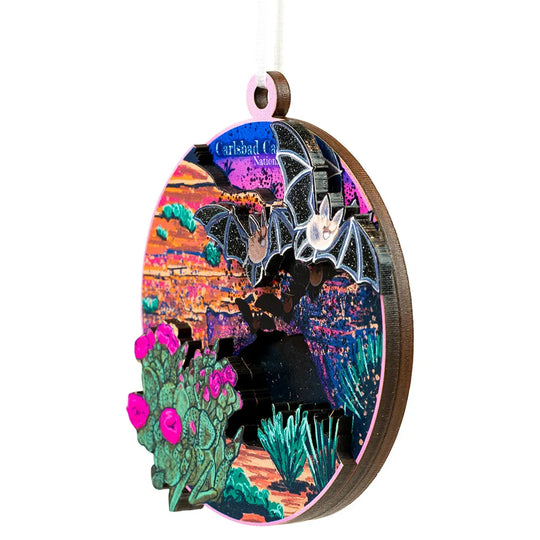 Decorative Carlsbad Caverns National Park ornament with bat and cactus design on a white background
