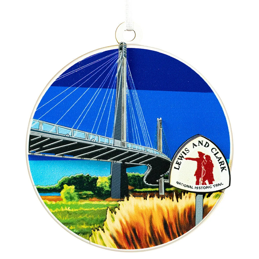 Circular ornament with a bridge and 'Lewis and Clark National Historic Trail' sign on a white background