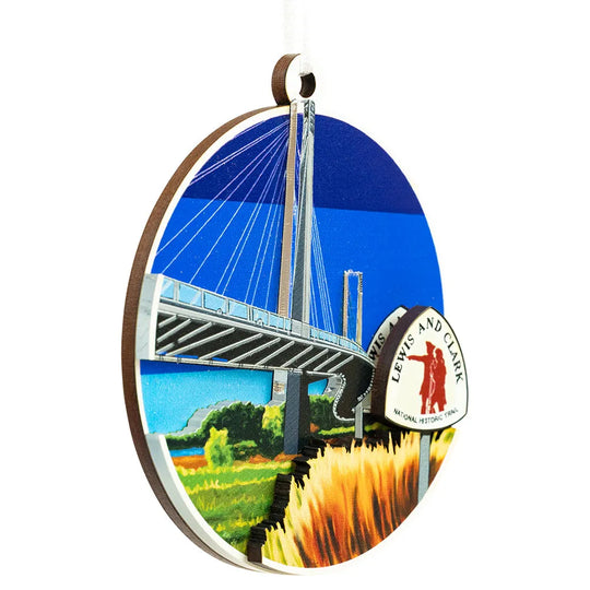 Decorative ornament with a bridge and scenic landscape design, featuring the Lewis and Clark National Historic Trail logo.