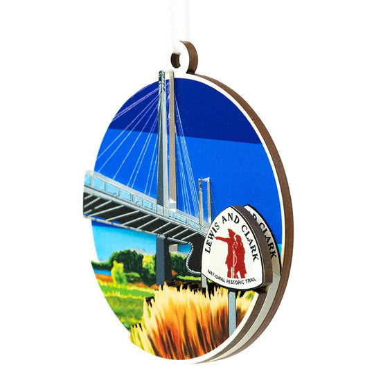 Decorative ornament with a bridge and 'Lewis and Clark National Historic Trail' logo on a white background