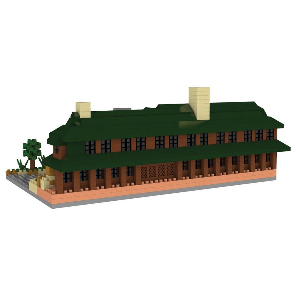 Min block set of the Lodge at Bryce Canyon National Park with a green roof and a flag, featuring a toy car in front on a white background.
