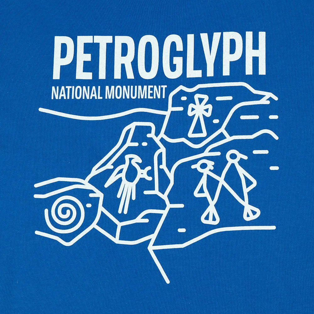 Blue t-shirt with white graphic and text for Petroglyph National Monument on a white background
