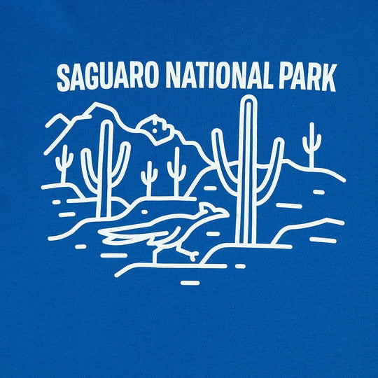 Saguaro National Park logo with cacti and mountains on a blue background