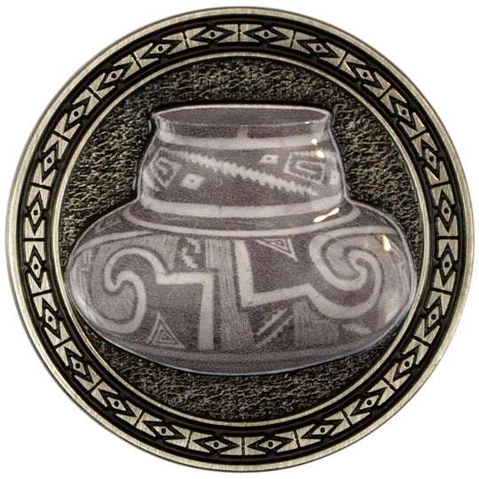 Metal collectible coin with a diamond patterned border surrounding a piece of pottery.