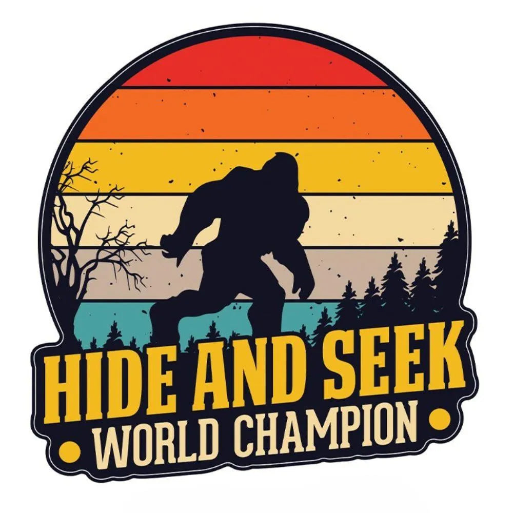 Vintage-style graphic with a silhouette of a bigfoot, trees, and a sunset with 'Hide and Seek World Champion' text.