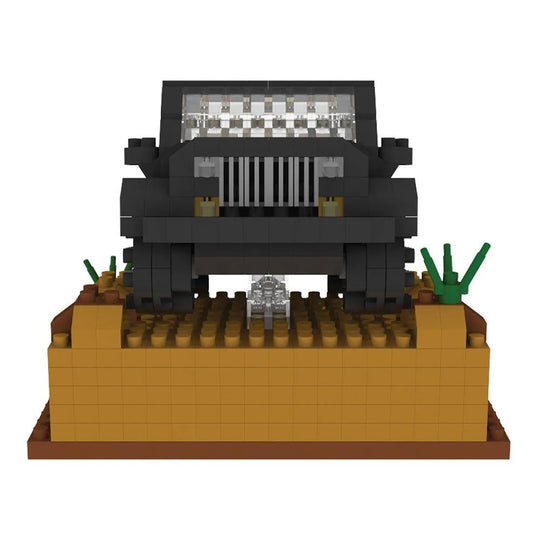 Box of mini building blocks off-road vehicle set with desert landscape design.