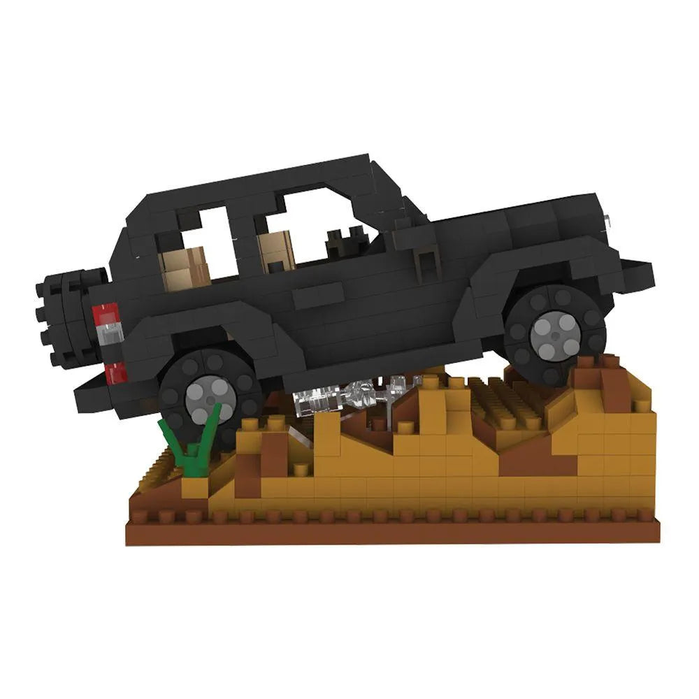 Box of mini building blocks off-road vehicle set with desert landscape design.