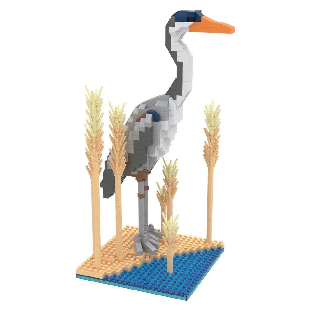 Mini building blocks set with a Great Blue Heron on a blue and tan baseplate surrounded by blocks made to look like reeds against a white background.