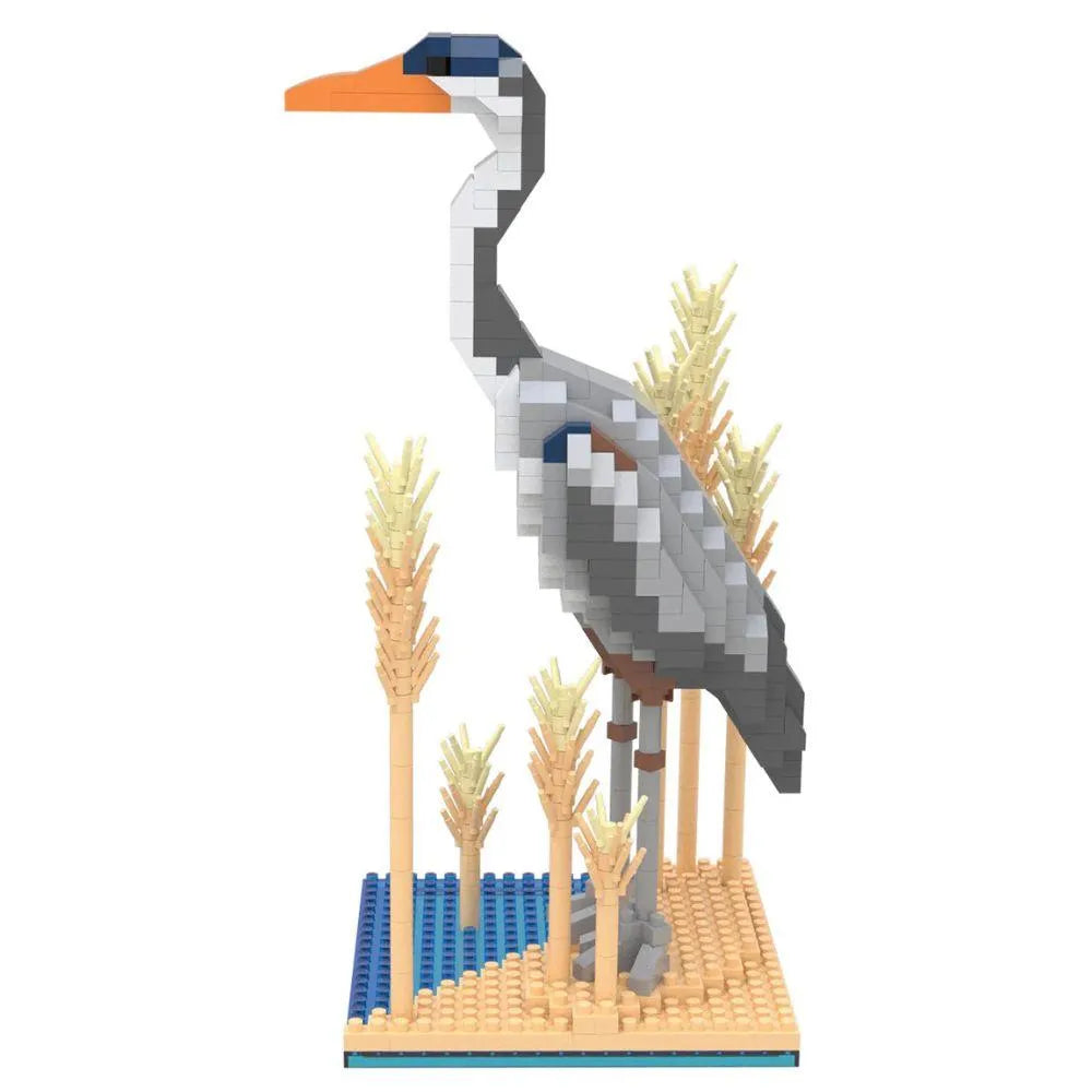 Mini building blocks set with a Great Blue Heron on a blue and tan baseplate surrounded by blocks made to look like reeds against a white background.