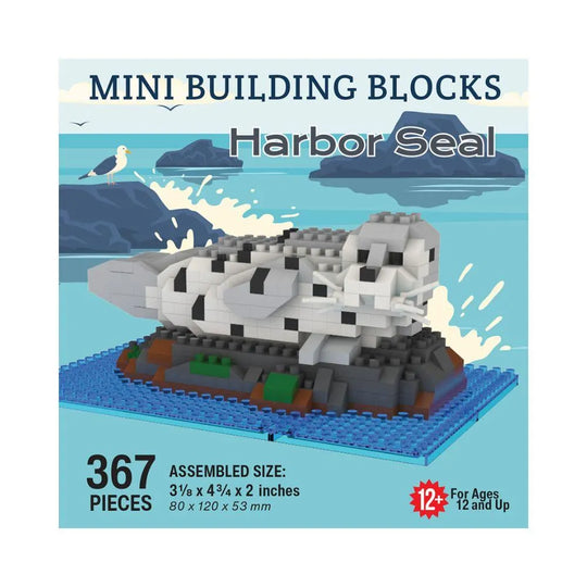 Box of mini building blocks shaped like a harbor seal with ocean and bird illustration.