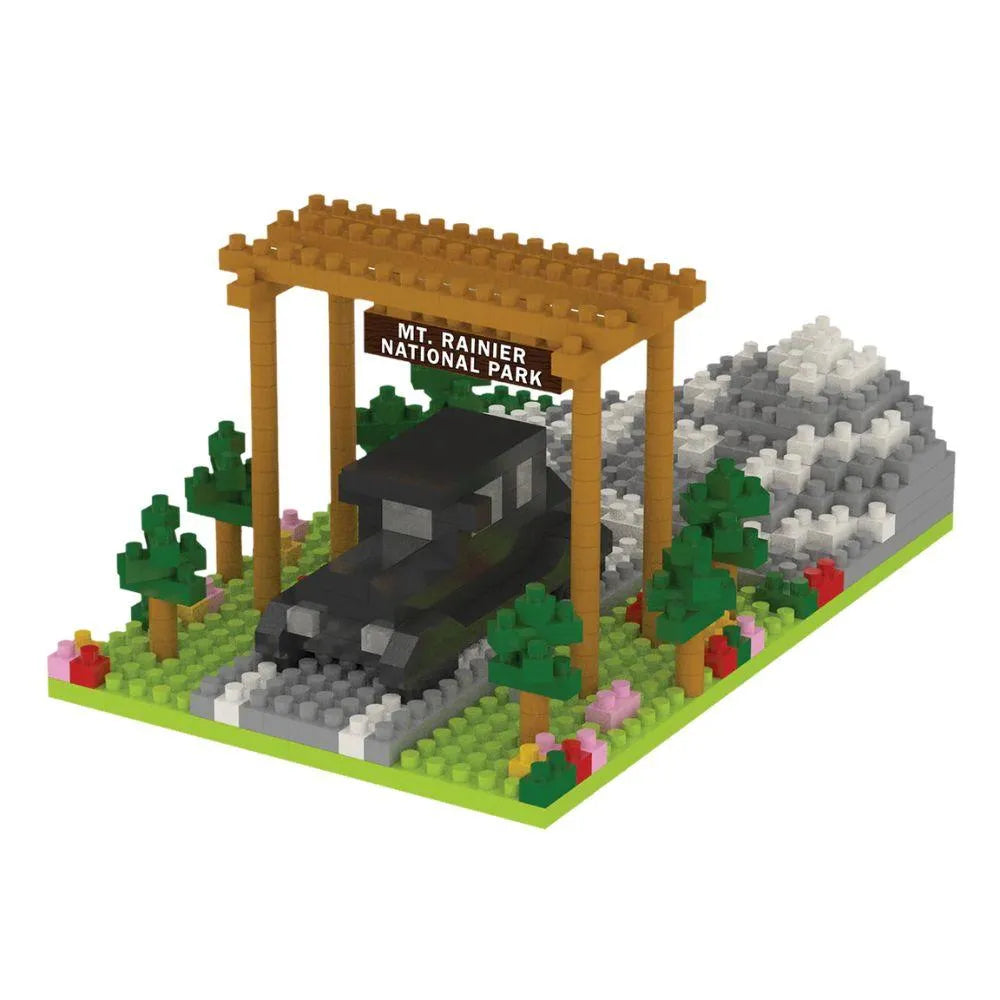 Mini block set of a truck under a wooden arch with 'Mt. Rainier National Park' sign, surrounded by trees and rocks on a white background.