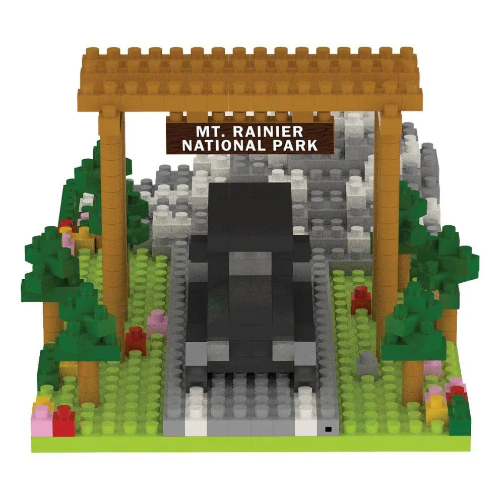 Mini block set of a truck under a wooden arch with 'Mt. Rainier National Park' sign, surrounded by trees and rocks on a white background.