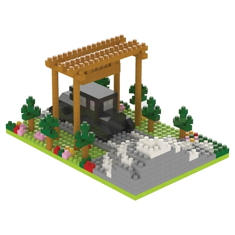 Mini block set of a truck under a wooden arch with 'Mt. Rainier National Park' sign, surrounded by trees and rocks on a white background.