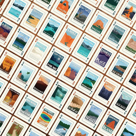 Pattern of playing cards with scenic illustrations on a brown background