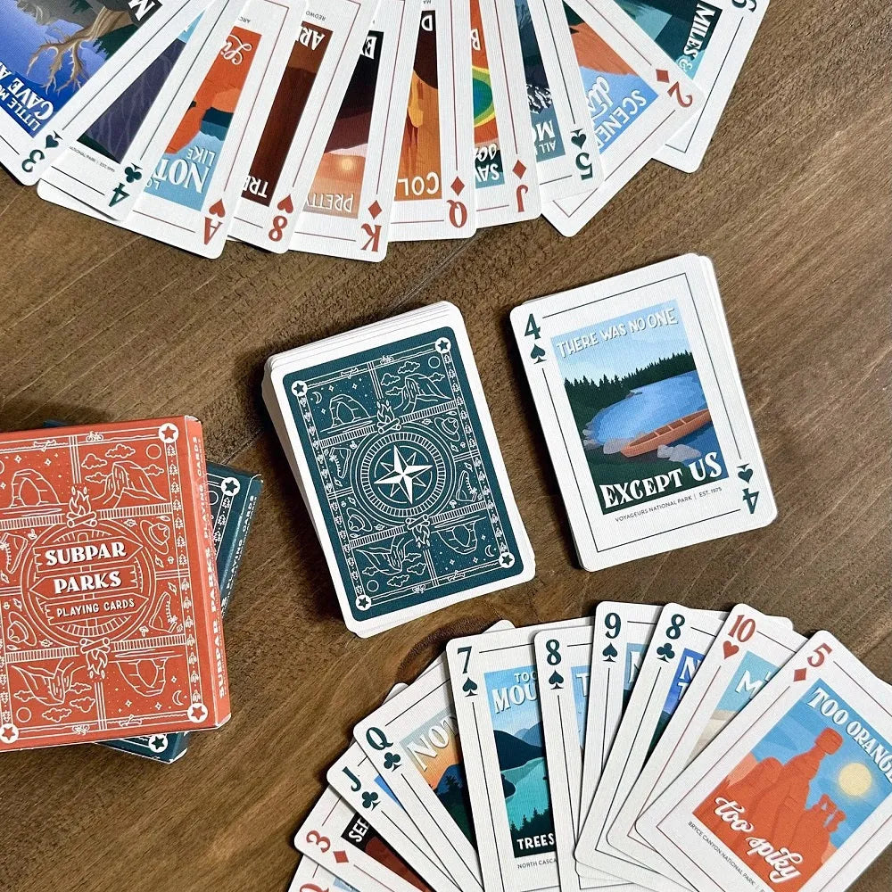 Playing cards with unique designs on a wooden surface