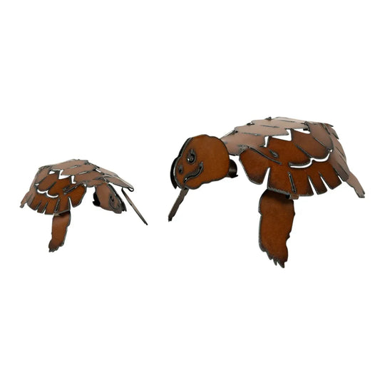 Metal yard art turtles on a white background