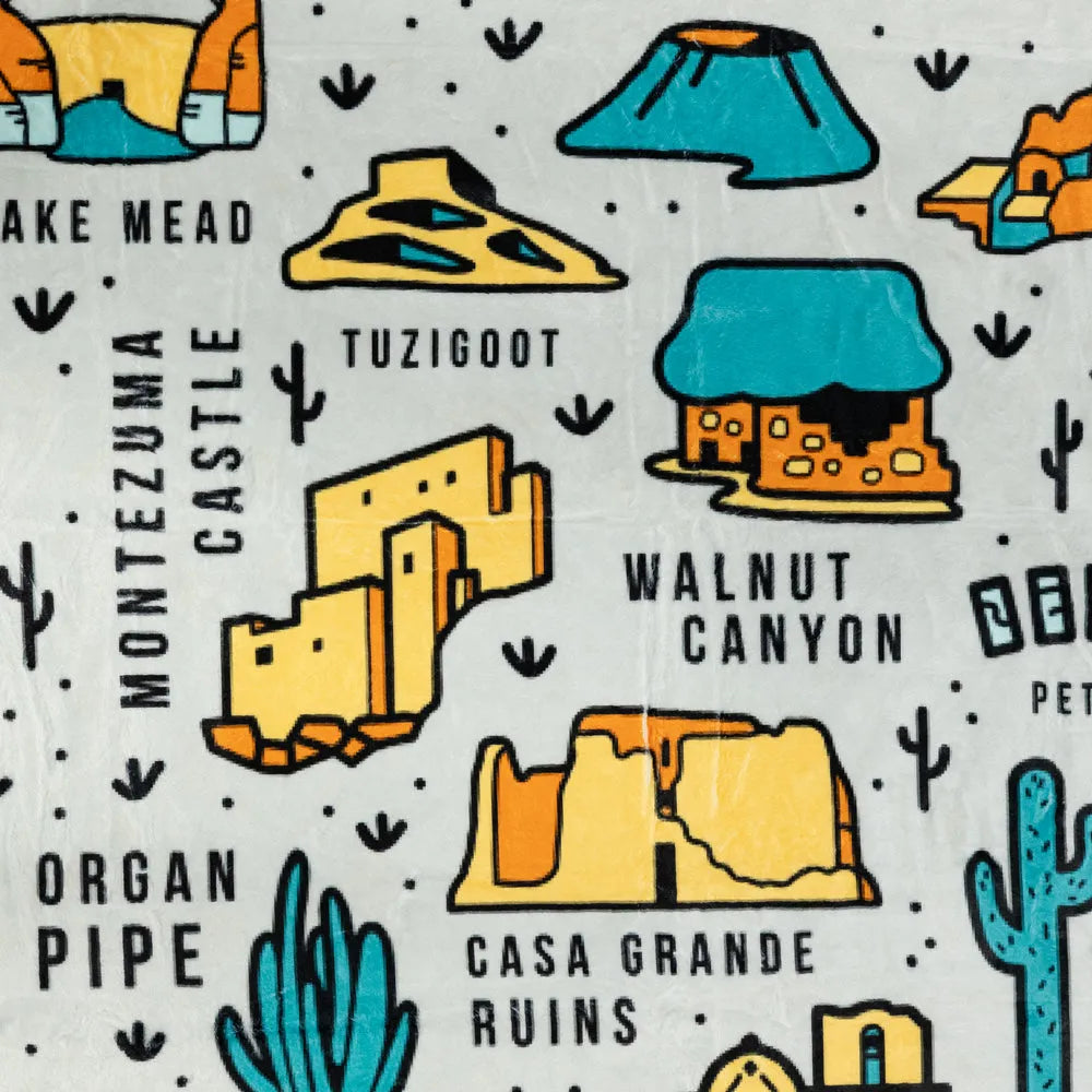 Pattern of desert-themed illustrations including ruins, cacti, and text on a white background.