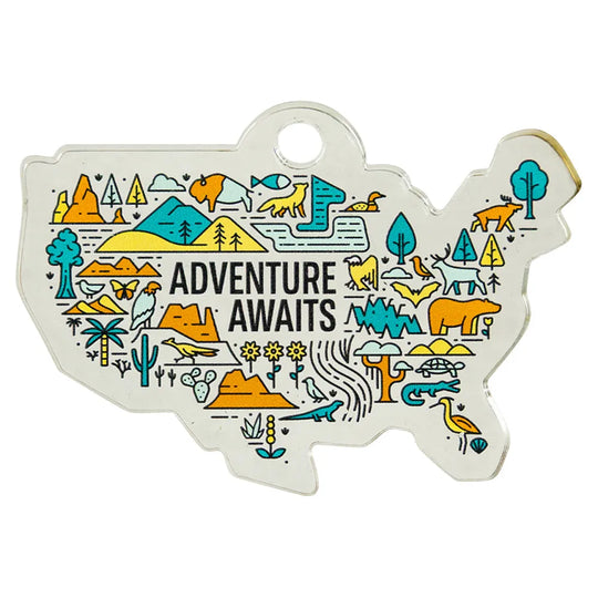 USA map-shaped ornament with nature-themed illustrations and 'Adventure Awaits' text on a white background.