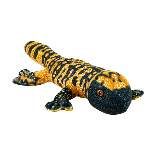 A realistic gila monster stuffed animal with a textured yellow and black pattern, isolated on a white background.