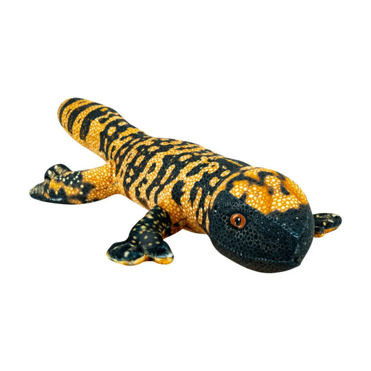 A realistic gila monster stuffed animal with a textured yellow and black pattern, isolated on a white background.