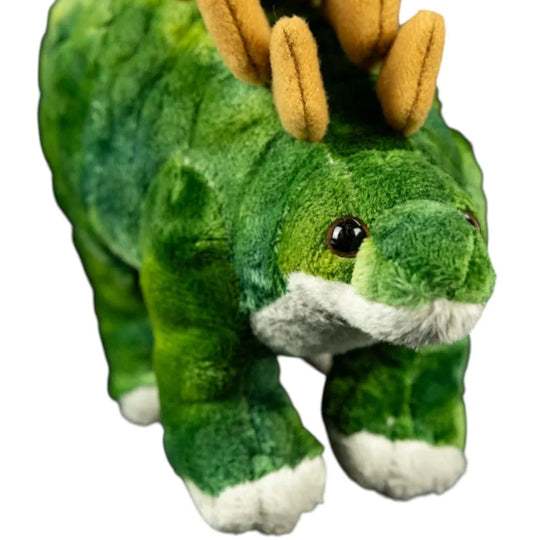 Green plush dinosaur toy with brown horns on a white background