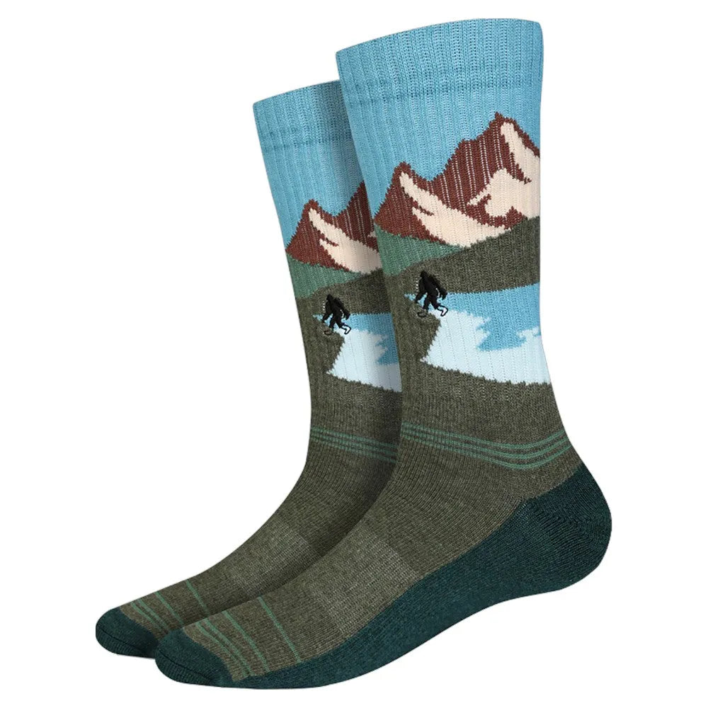 Pair of socks with mountain and bigfoot design on a white background