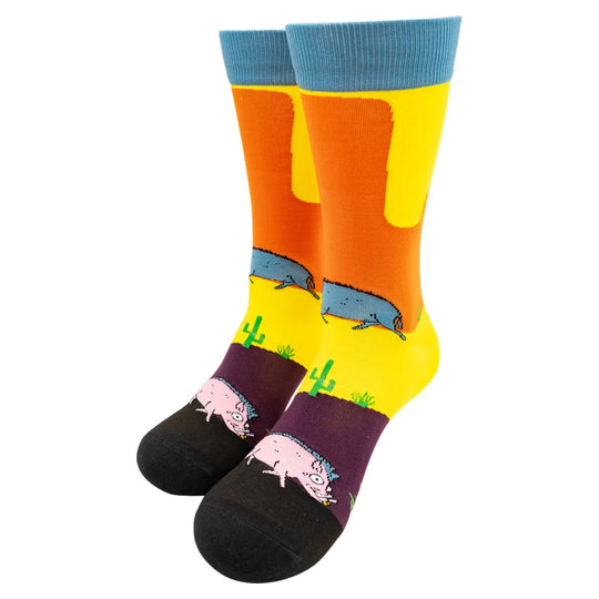 Pair of blue, yellow, and orange knit socks with whimsical javalina design on a white background