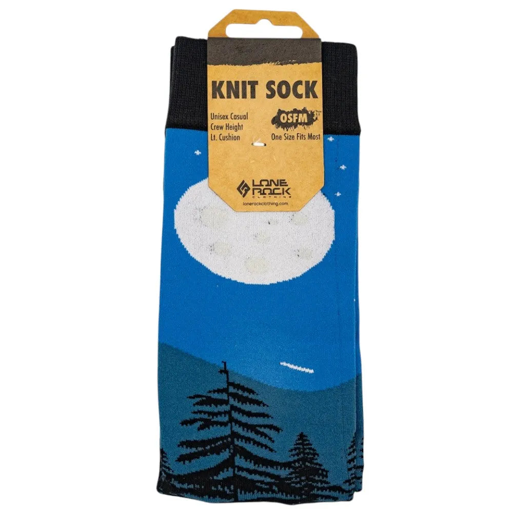 Knit sock with a full moon night sky and a mountain and tree design in packaging