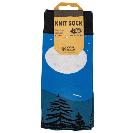 Knit sock with a full moon night sky and a mountain and tree design in packaging