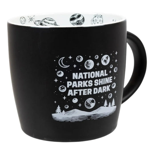 Black mug with "National Parks Shine After Dark" graphic and text on a white background