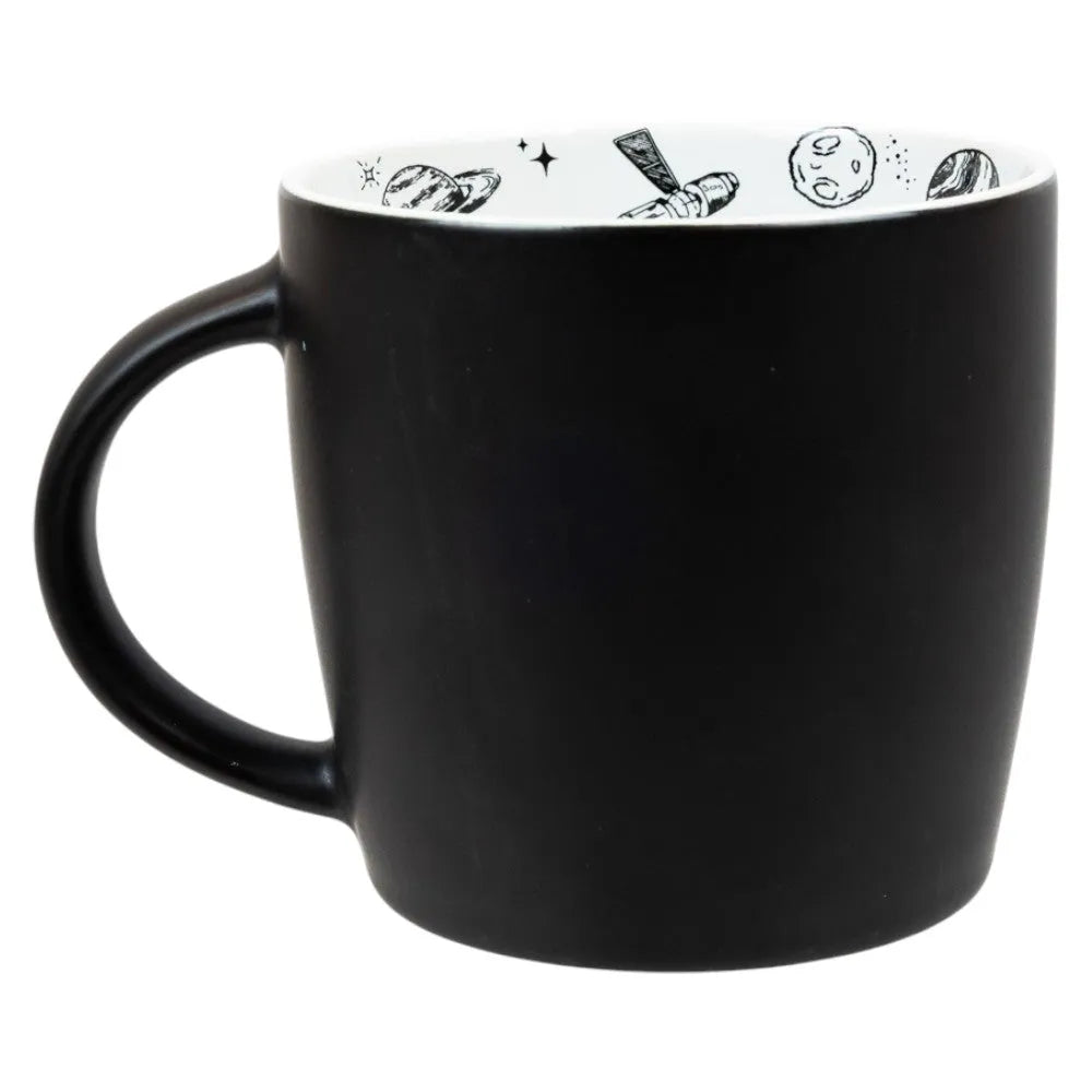 Black mug with white interior featuring various celestial designs on a white background