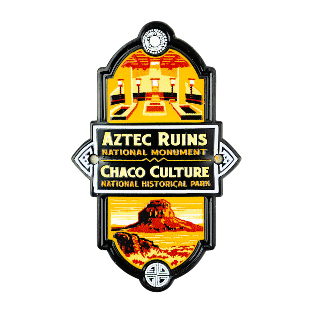 Aztec Ruins National Monument and Chaco Culture National Historical Park enamel pin featuring a vintage-style illustration bordered in black with gold and white text.