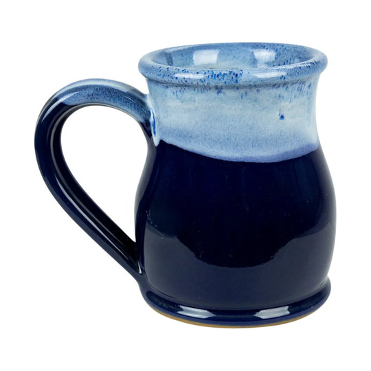 A ceramic mug with a glossy dark blue body and a lighter speckled blue glazed rim, shown on a plain white background.