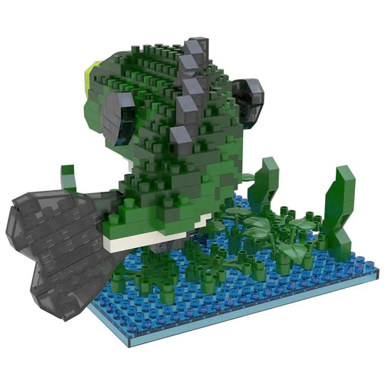 Toy figure of a green bass fish on a blue base with green plants, on a white background