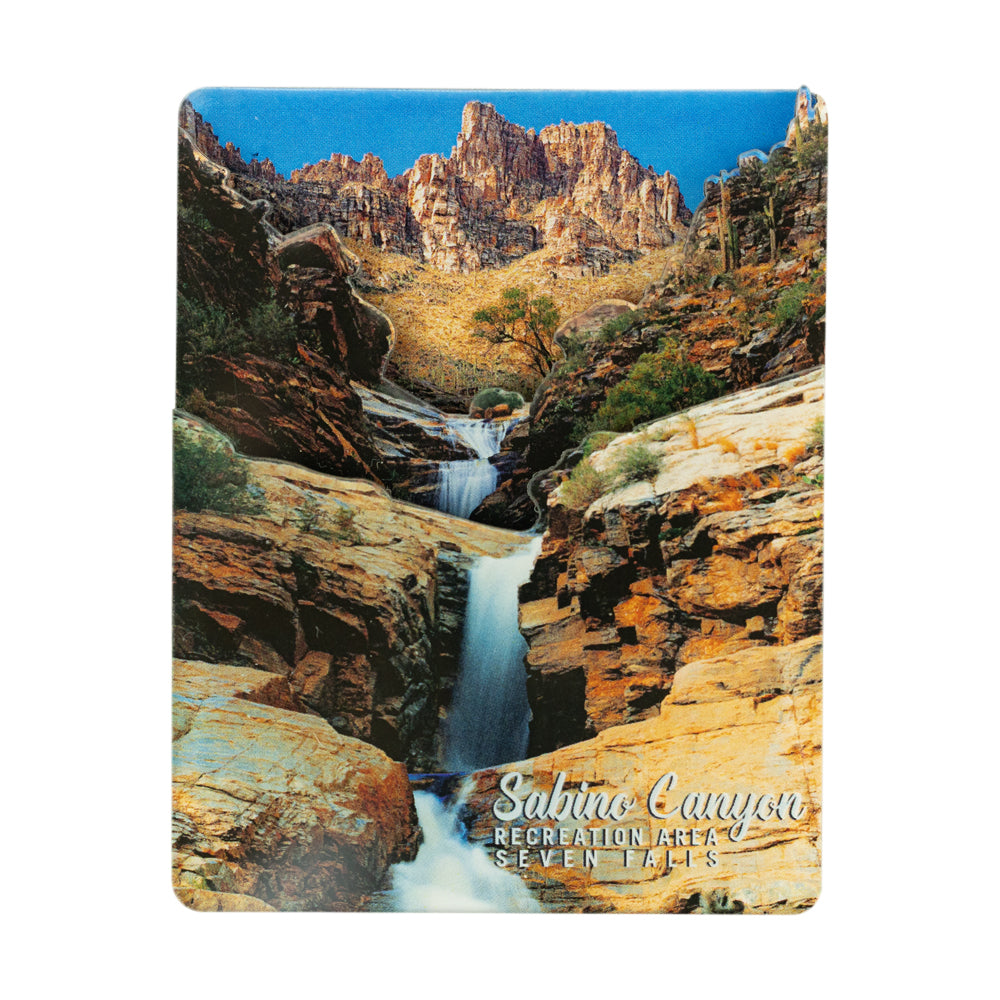 A rectangular acrylic magnet featuring a scenic landscape of Sobino Canyon with a waterfall, rocky cliffs, and blue sky. The words &