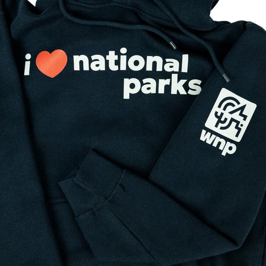 A close-up of a dark navy hoodie featuring a white graphic that reads &