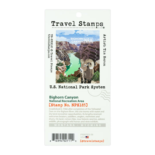 A Travel Stamps Bighorn Canyon National Park stamp card featuring an illustration of a bighorn sheep in a canyon with turquoise water, labeled with U.S.