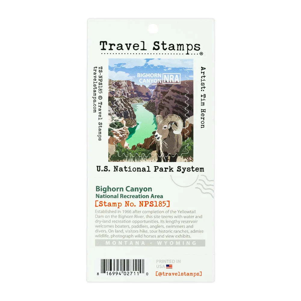 A Travel Stamps Bighorn Canyon National Park stamp card featuring an illustration of a bighorn sheep in a canyon with turquoise water, labeled with U.S.