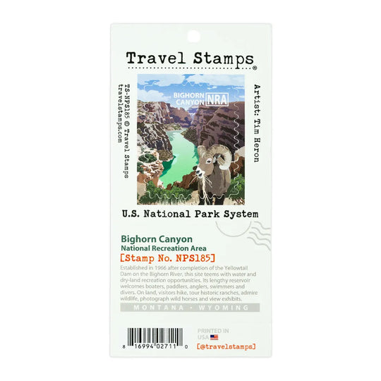 A Travel Stamps Bighorn Canyon National Park stamp card featuring an illustration of a bighorn sheep in a canyon with turquoise water, labeled with U.S.