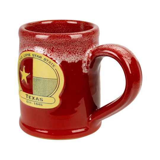 A glossy red ceramic mug with a Texas state seal decal on the side, isolated on a white background.