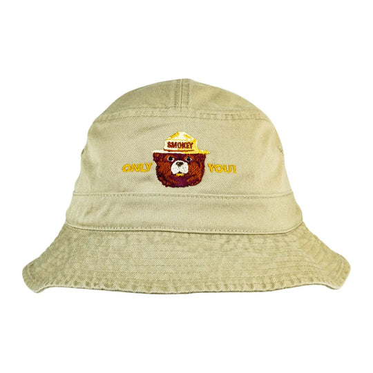 A light beige bucket hat featuring an embroidered design of a bear wearing a yellow ranger hat with &