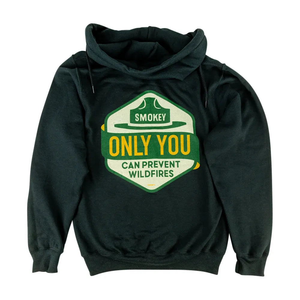 A dark gray pullover hoodie with a large graphic printed on the back of a shield shape with a green and cream background, featuring the text 'Smokey Only You Can Prevent Wildfires' in yellow and white.