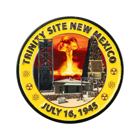 A circular commemorative pin reading &